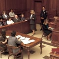 Where does the defense attorney sit in court?