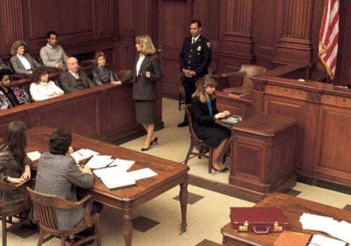 Where does the defense attorney sit in court?
